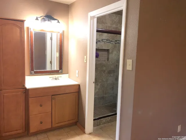 a bathroom with a sink and mirror