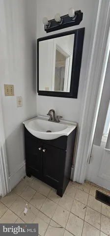 a bathroom with a sink vanity and mirror