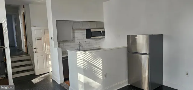 a kitchen with a refrigerator and an oven
