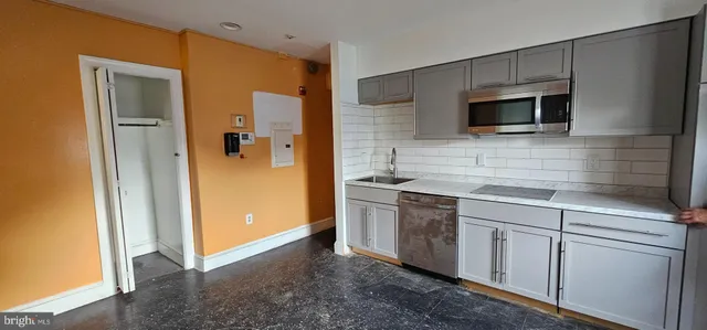 a kitchen with stainless steel appliances granite countertop a refrigerator and a sink