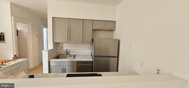 a kitchen with a refrigerator and a sink