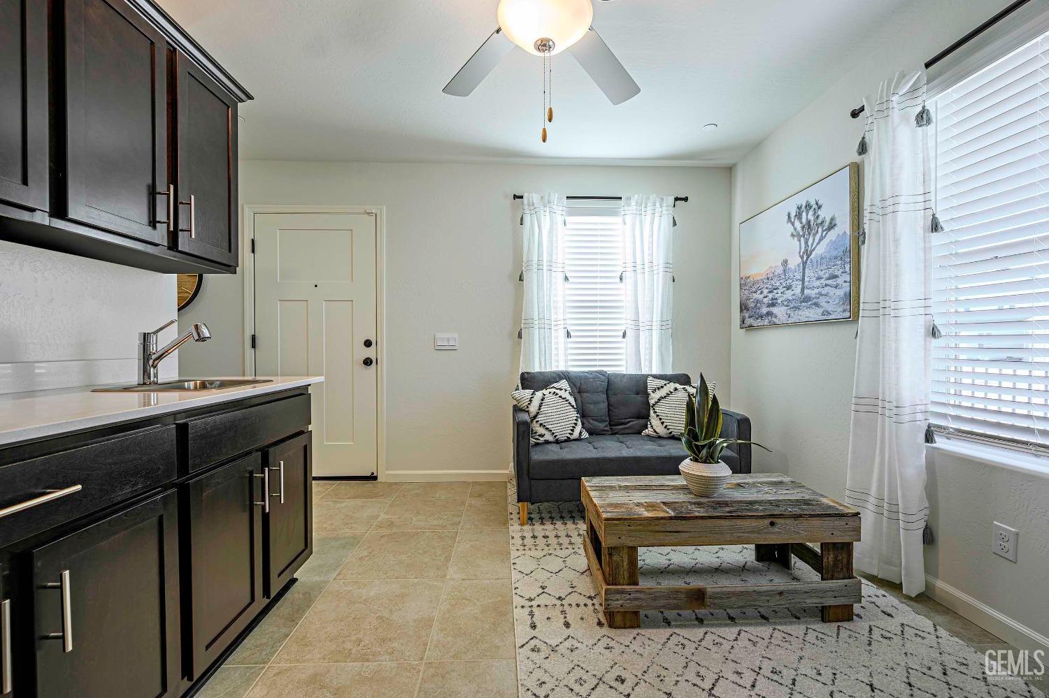 Undisclosed Address Bakersfield, CA 93313 - Photo 14 of 34 a living room with a couch and a window