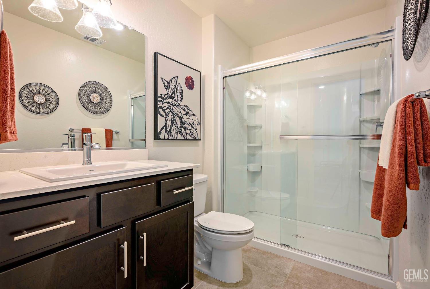 Undisclosed Address Bakersfield, CA 93313 - Photo 15 of 34 a bathroom with a sink a toilet and a shower