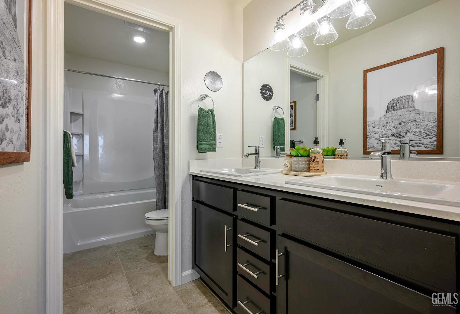 Undisclosed Address Bakersfield, CA 93313 - Photo 25 of 34 a bathroom with a tub a sink and a large mirror