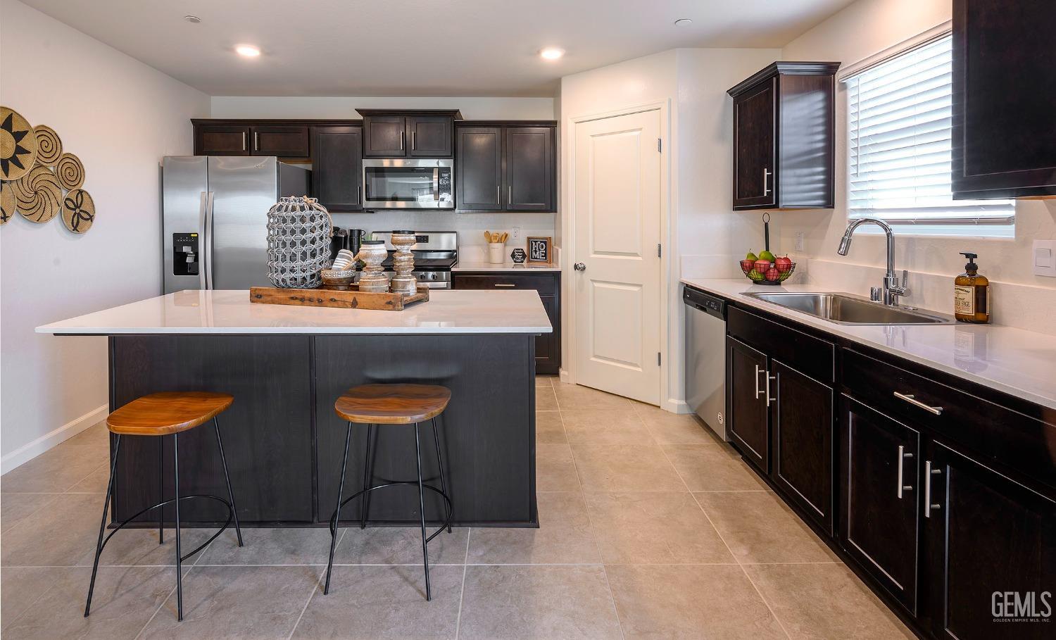 Undisclosed Address Bakersfield, CA 93313 - Photo 4 of 34 a kitchen with stainless steel appliances granite countertop a sink stove and refrigerator