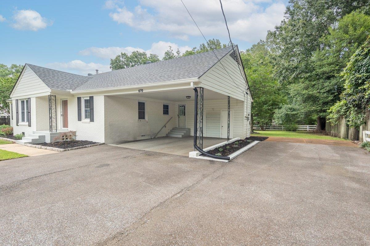 670 Peterson Lake Road Collierville, TN 38017 - Photo 3 of 37 White brick exterior with a dark gray shingle roof