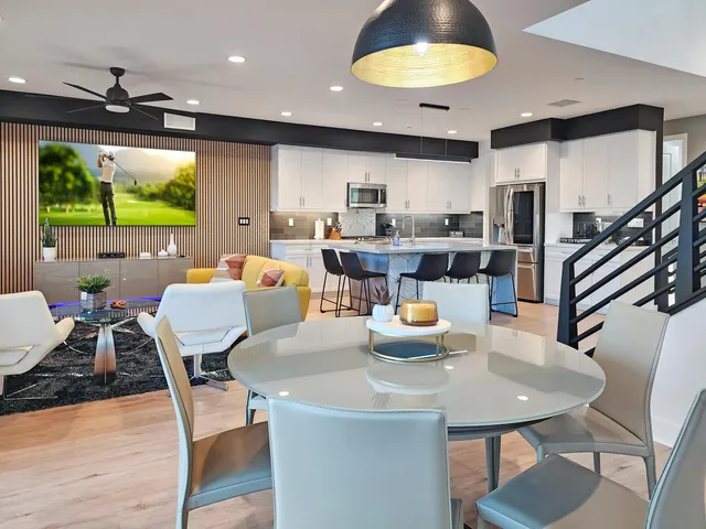 a view of a dining room with furniture and a chandelier