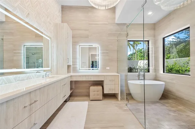 a bathroom with a tub sink and mirror