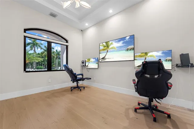 a view of a workspace with furniture and a window