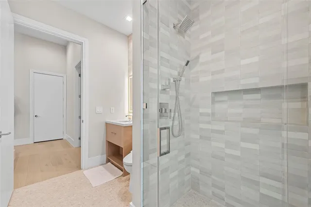 a bathroom with a shower and a sink