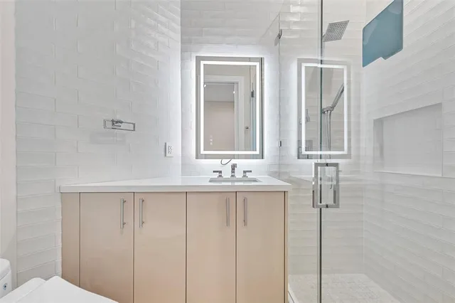 a bathroom with two sink and a mirror