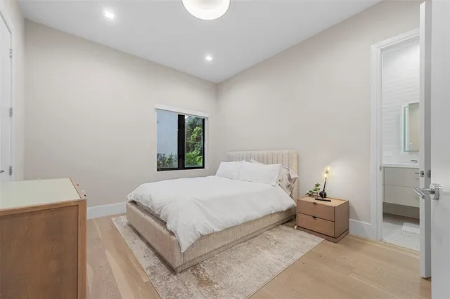 a bedroom with a bed and a table