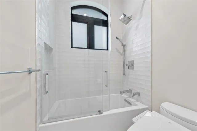 a white bath tub sitting next to a white toilet