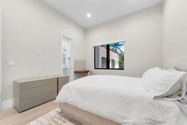 a bedroom with a bed and a painting