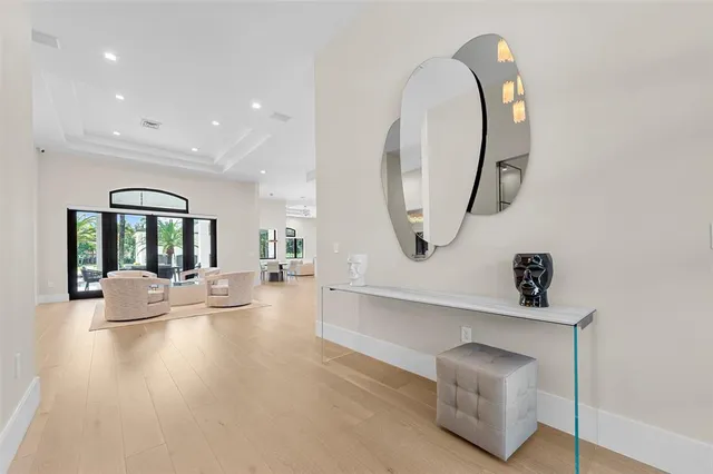 a view of living room filled with furniture and a mirror