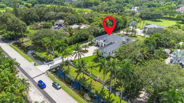 an aerial view of residential houses with outdoor space and swimming pool