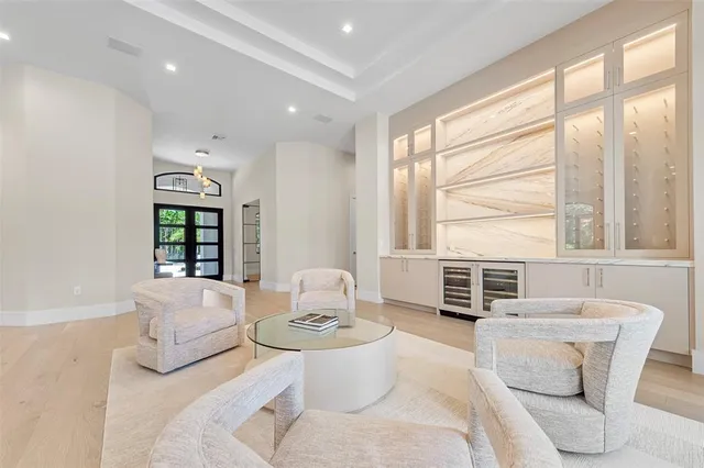 a living room with furniture and large windows