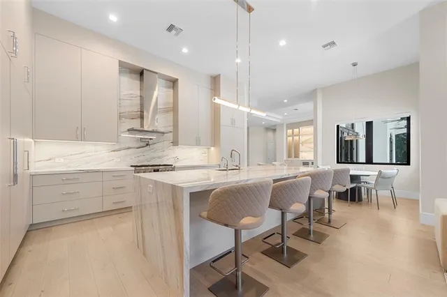 a kitchen with a sink stove and white cabinets
