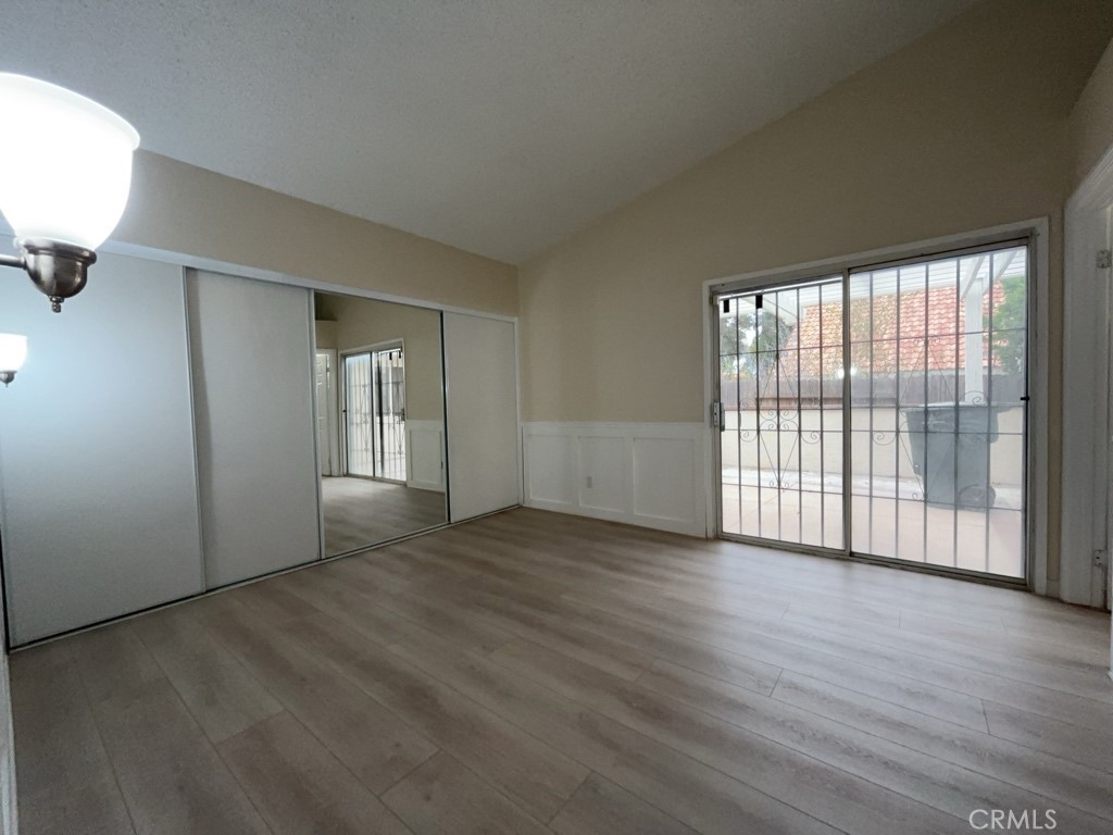 9263 Owari Lane Riverside, CA 92508 - Photo 13 of 17 an empty room with wooden floor and windows