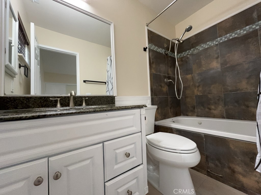 9263 Owari Lane Riverside, CA 92508 - Photo 15 of 17 a bathroom with a sink a toilet and a bathtub