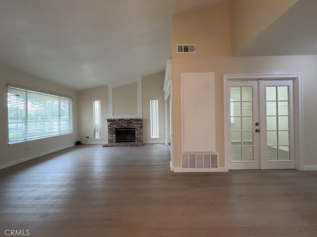 9263 Owari Lane Riverside, CA 92508 - Photo 3 of 17 an empty room with fireplace and windows