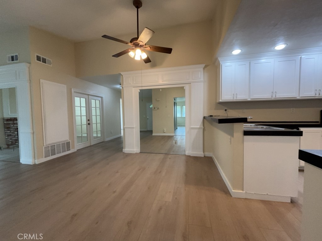 9263 Owari Lane Riverside, CA 92508 - Photo 4 of 17 a view of a kitchen with a stove cabinets and wooden floor