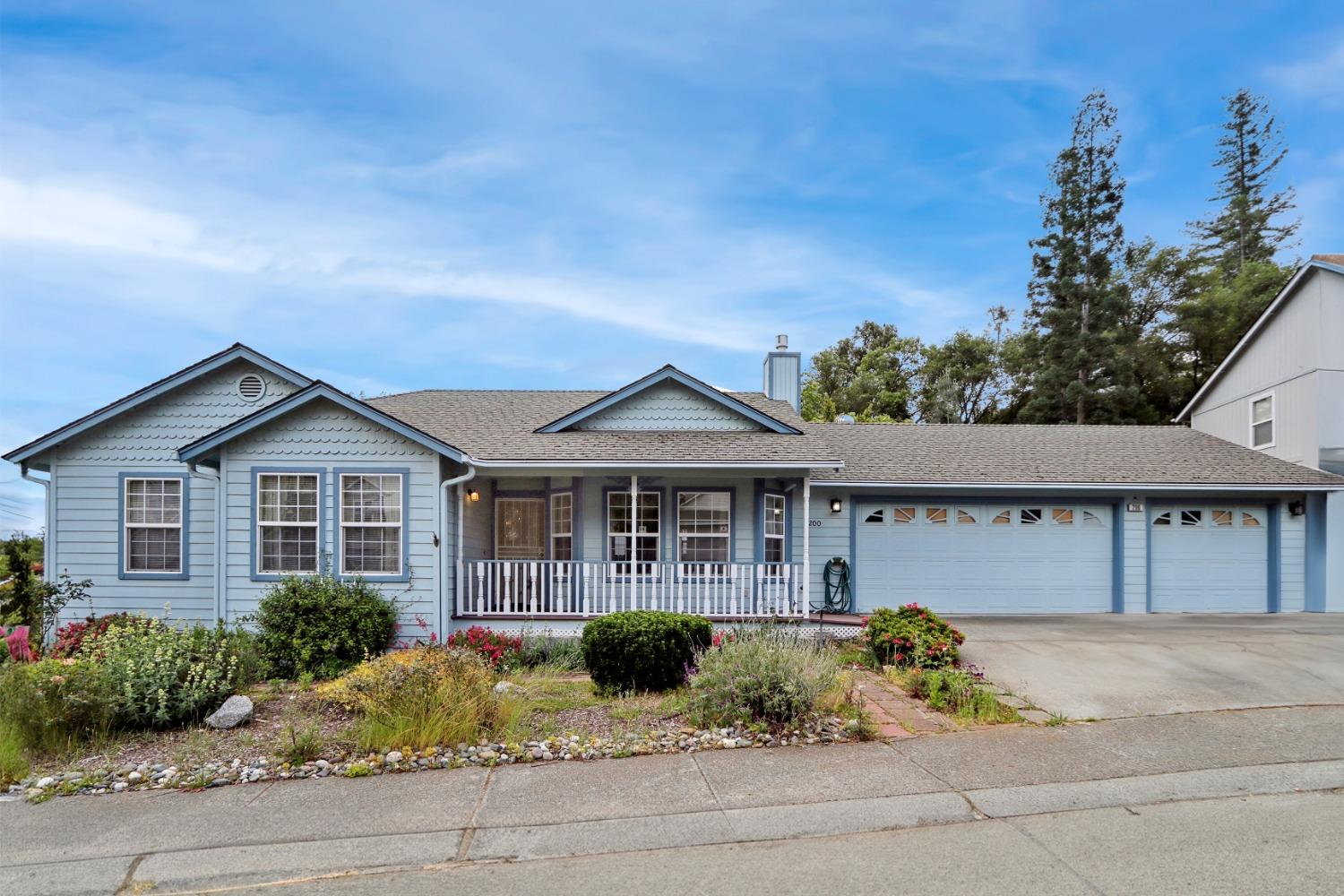 200 Hidden Glen Drive Auburn, CA 95603 - Photo 1 of 1 a front view of a house with a garden