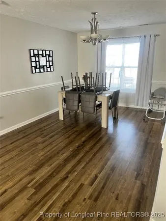 wooden floor in a hall with a dining table chairs