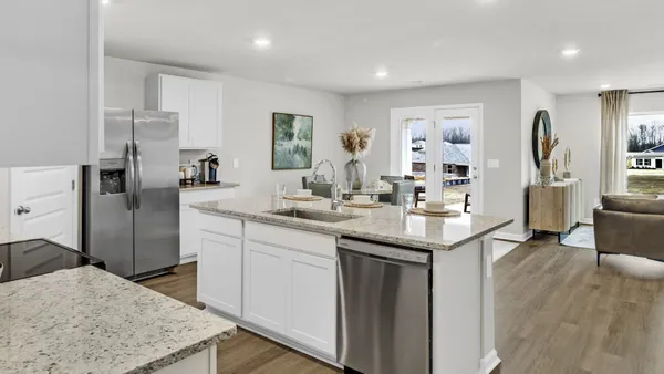 a kitchen with stainless steel appliances granite countertop a sink refrigerator and cabinets