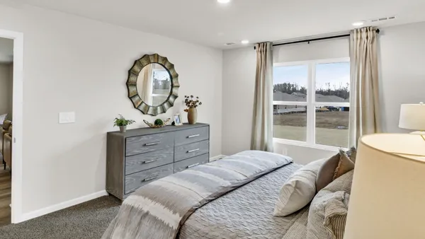 a bedroom with a bed and a dresser