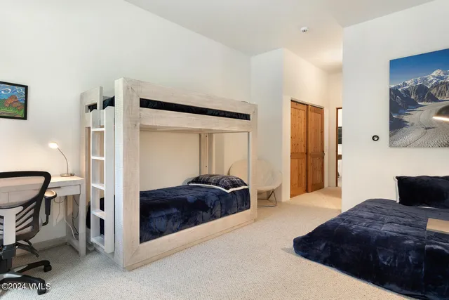 a bedroom with a bed and cabinets