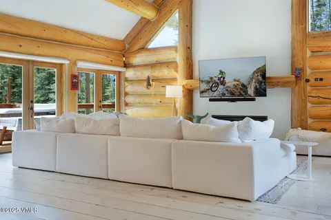 a living room with furniture and large windows