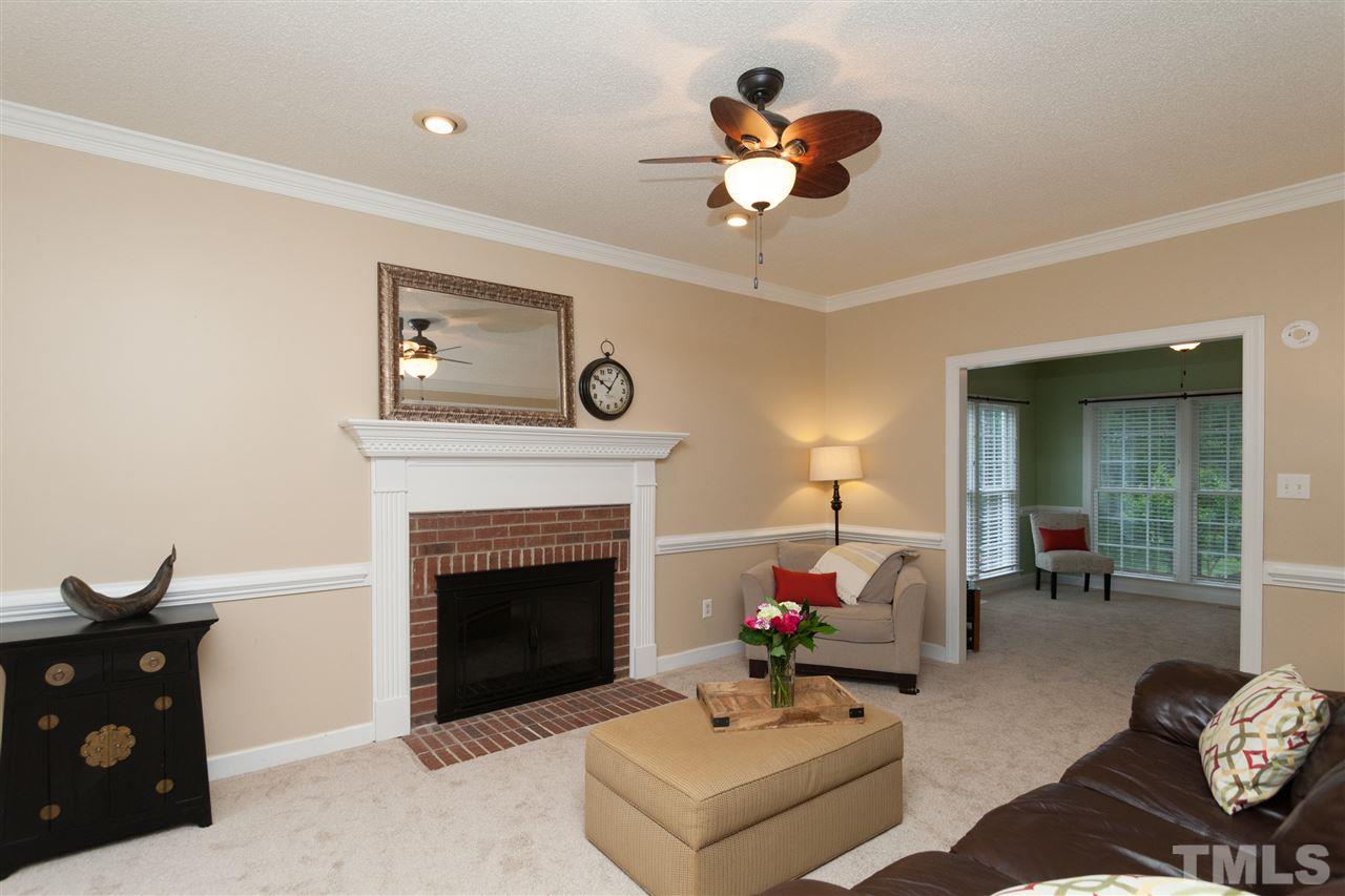 124 Huntsmoor Lane Cary, NC 27513 - Photo 2 of 25 a living room with furniture and a fireplace