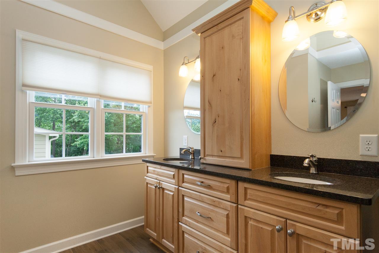 124 Huntsmoor Lane Cary, NC 27513 - Photo 11 of 25 a bathroom with a sink and a mirror