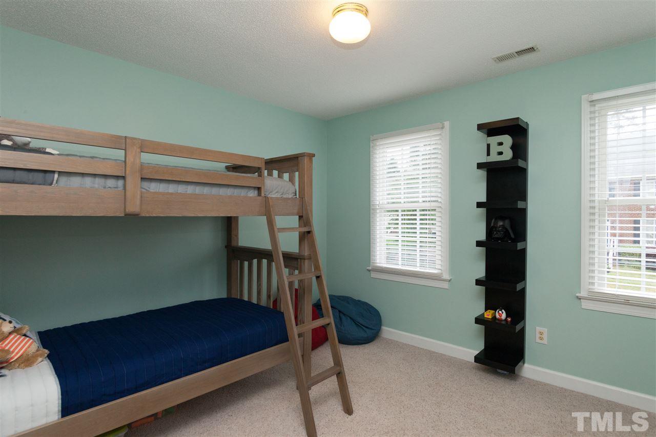 124 Huntsmoor Lane Cary, NC 27513 - Photo 13 of 25 a bedroom with a bed and a window