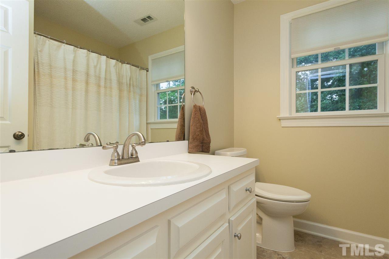 124 Huntsmoor Lane Cary, NC 27513 - Photo 15 of 25 a bathroom with a sink a toilet and a mirror