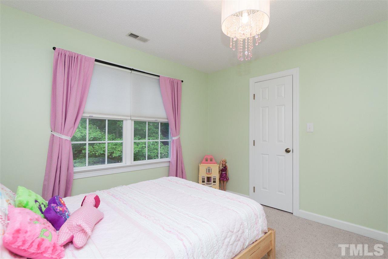 124 Huntsmoor Lane Cary, NC 27513 - Photo 16 of 25 a bedroom with a bed and a window