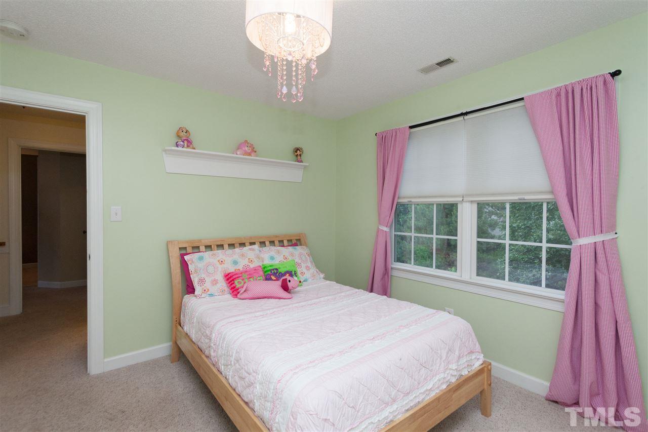 124 Huntsmoor Lane Cary, NC 27513 - Photo 17 of 25 a bedroom with a bed and a window