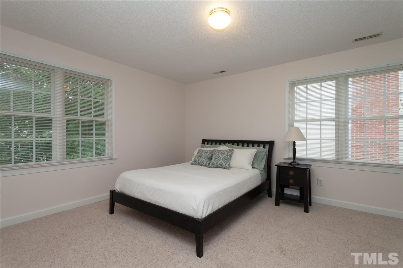 124 Huntsmoor Lane Cary, NC 27513 - Photo 18 of 25 a bed sitting in a bedroom next to a window