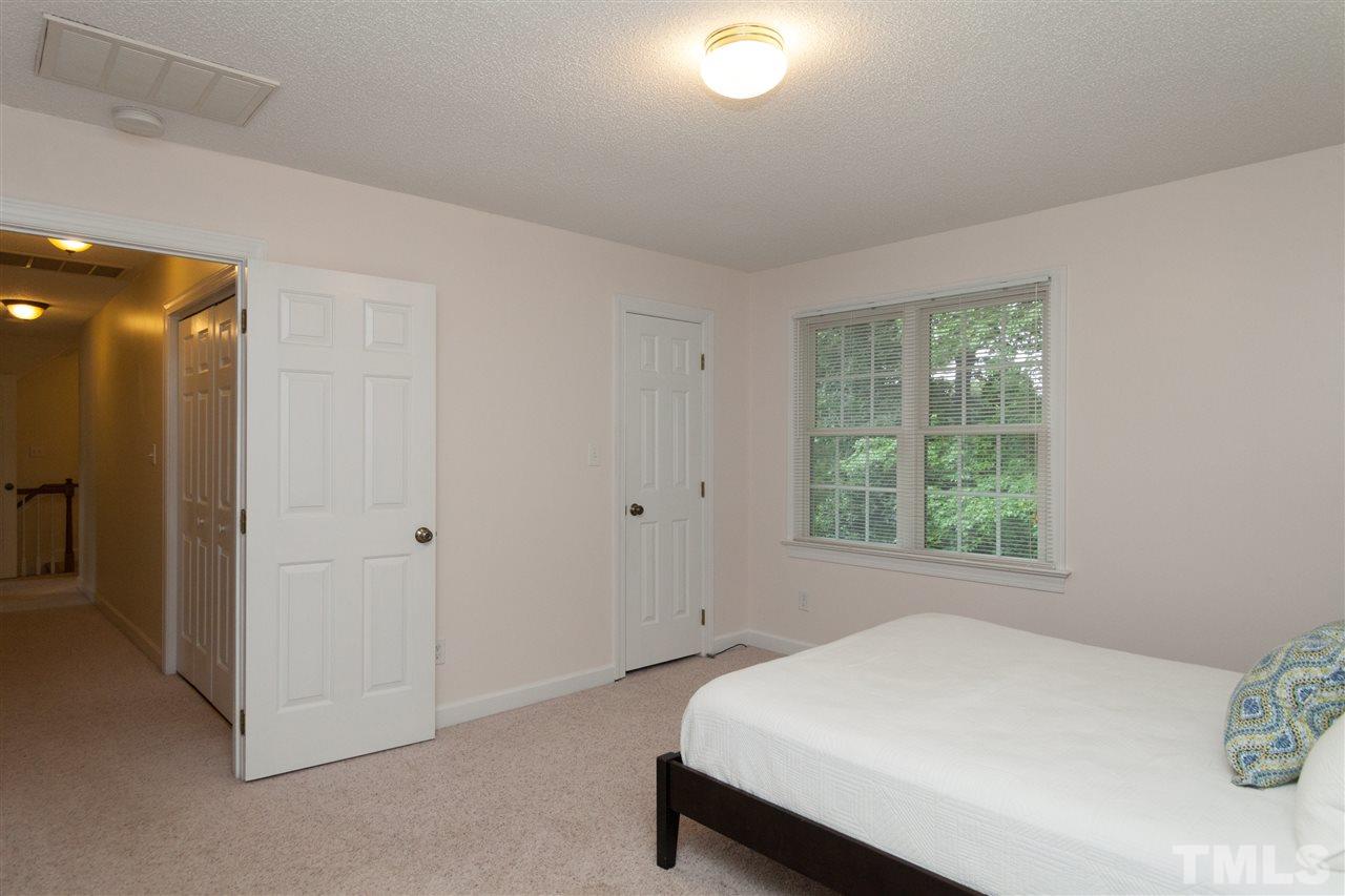 124 Huntsmoor Lane Cary, NC 27513 - Photo 19 of 25 a room with a bed and a window
