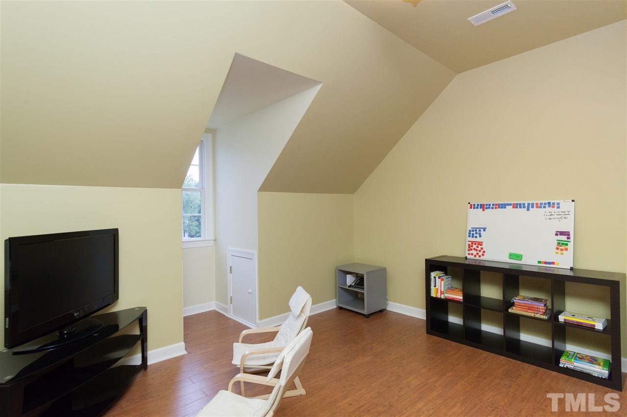 124 Huntsmoor Lane Cary, NC 27513 - Photo 20 of 25 a living room with furniture and a flat screen tv
