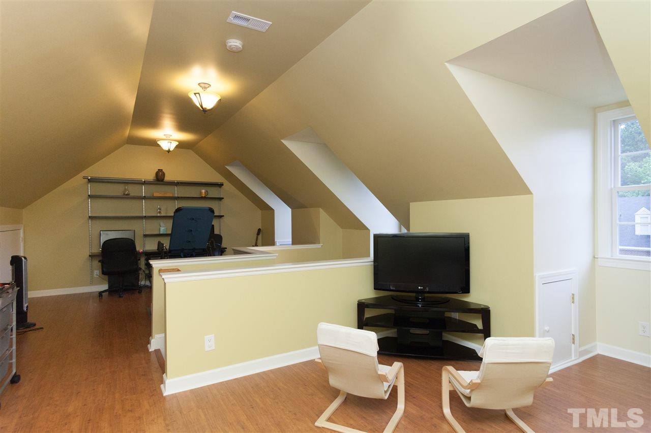 124 Huntsmoor Lane Cary, NC 27513 - Photo 22 of 25 a living room with furniture and a flat screen tv