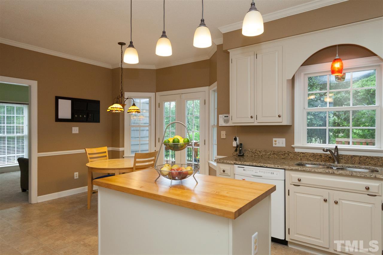 124 Huntsmoor Lane Cary, NC 27513 - Photo 8 of 25 a kitchen with stainless steel appliances granite countertop a sink a stove and a granite counter top