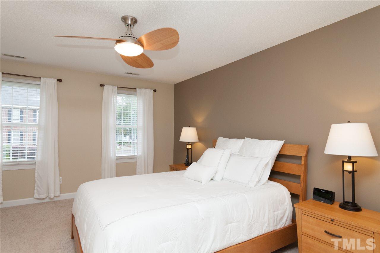 124 Huntsmoor Lane Cary, NC 27513 - Photo 9 of 25 a bedroom with a bed and a lamp