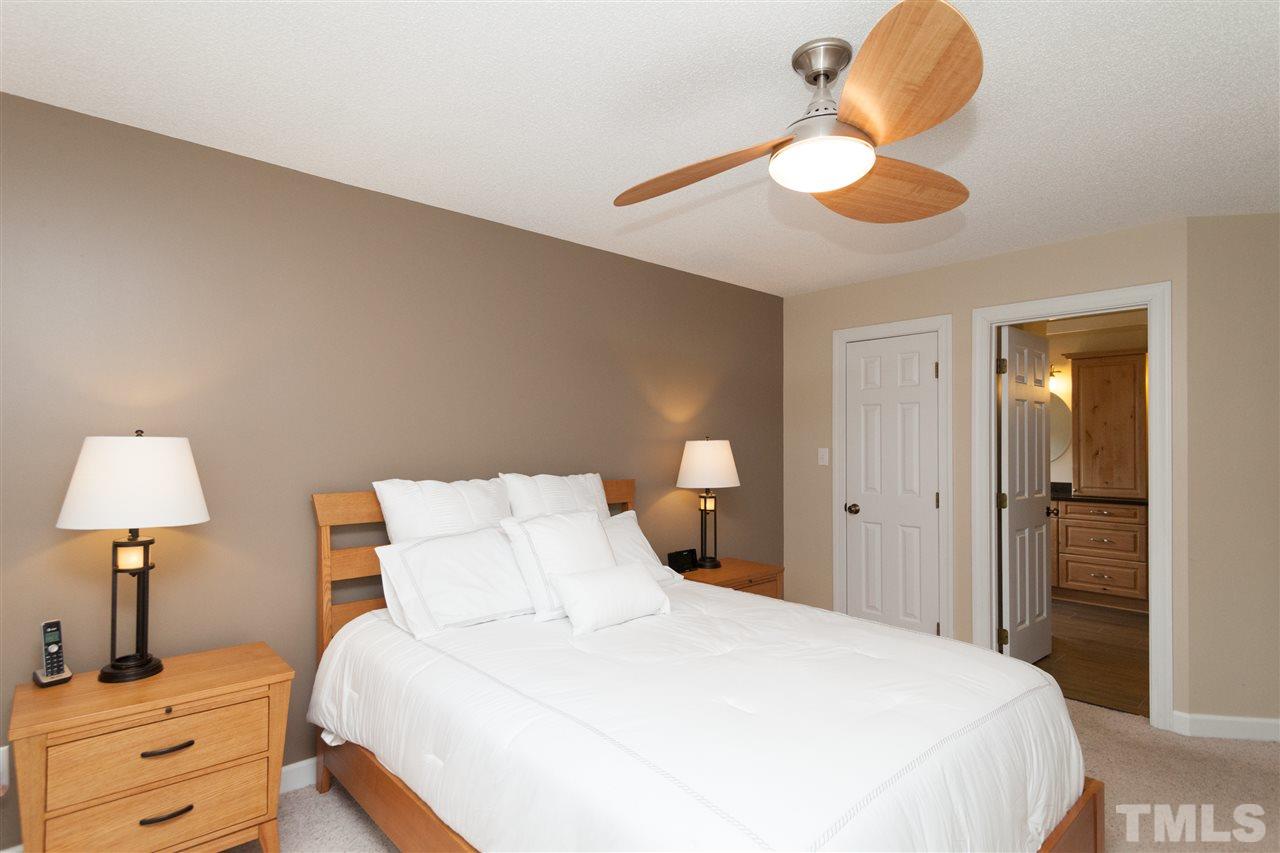 124 Huntsmoor Lane Cary, NC 27513 - Photo 10 of 25 a bedroom with a bed and a lamp