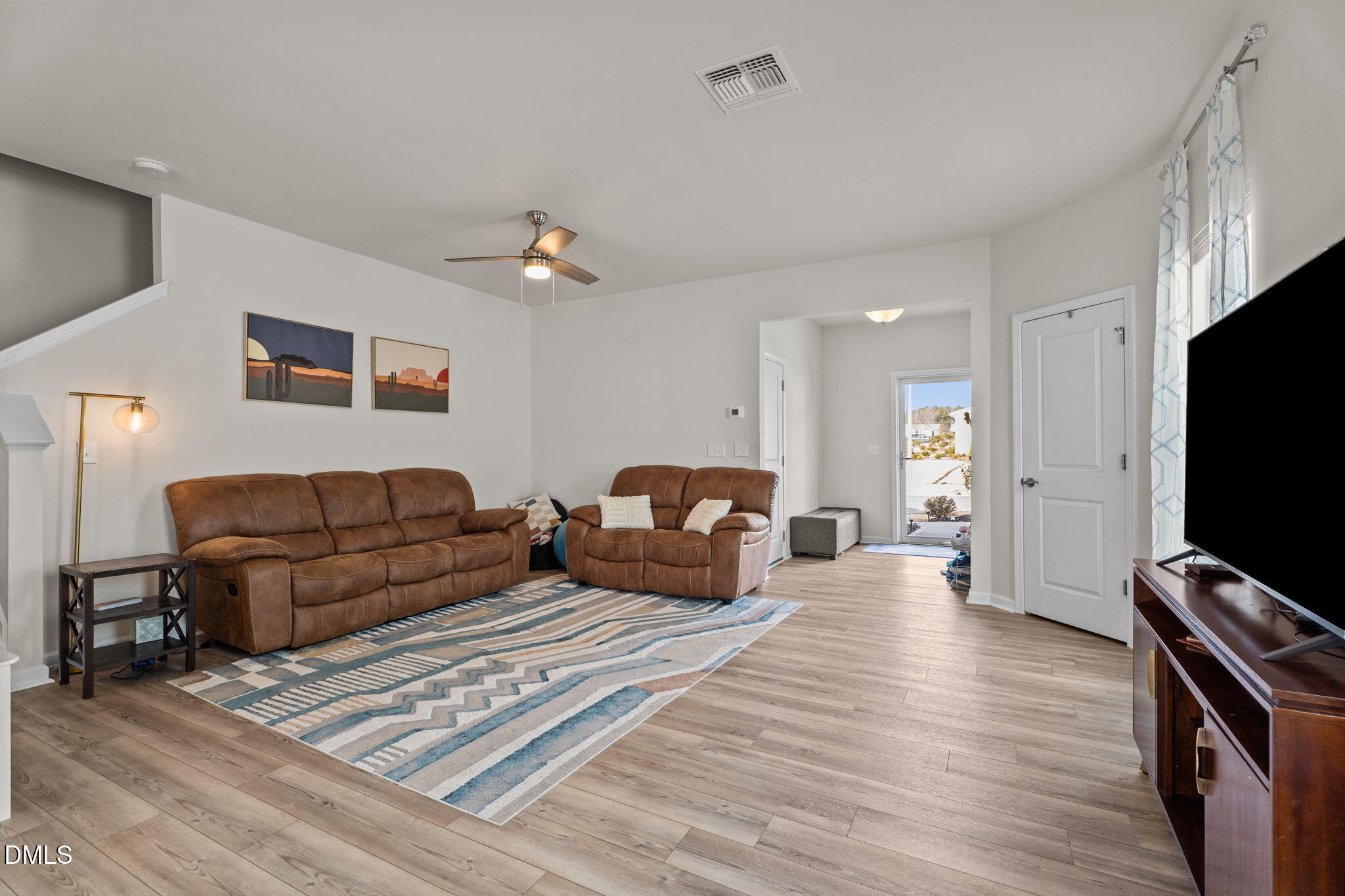 1572 Rhodes Pond Street Wendell, NC 27591 - Photo 11 of 42 a living room with furniture and a flat screen tv