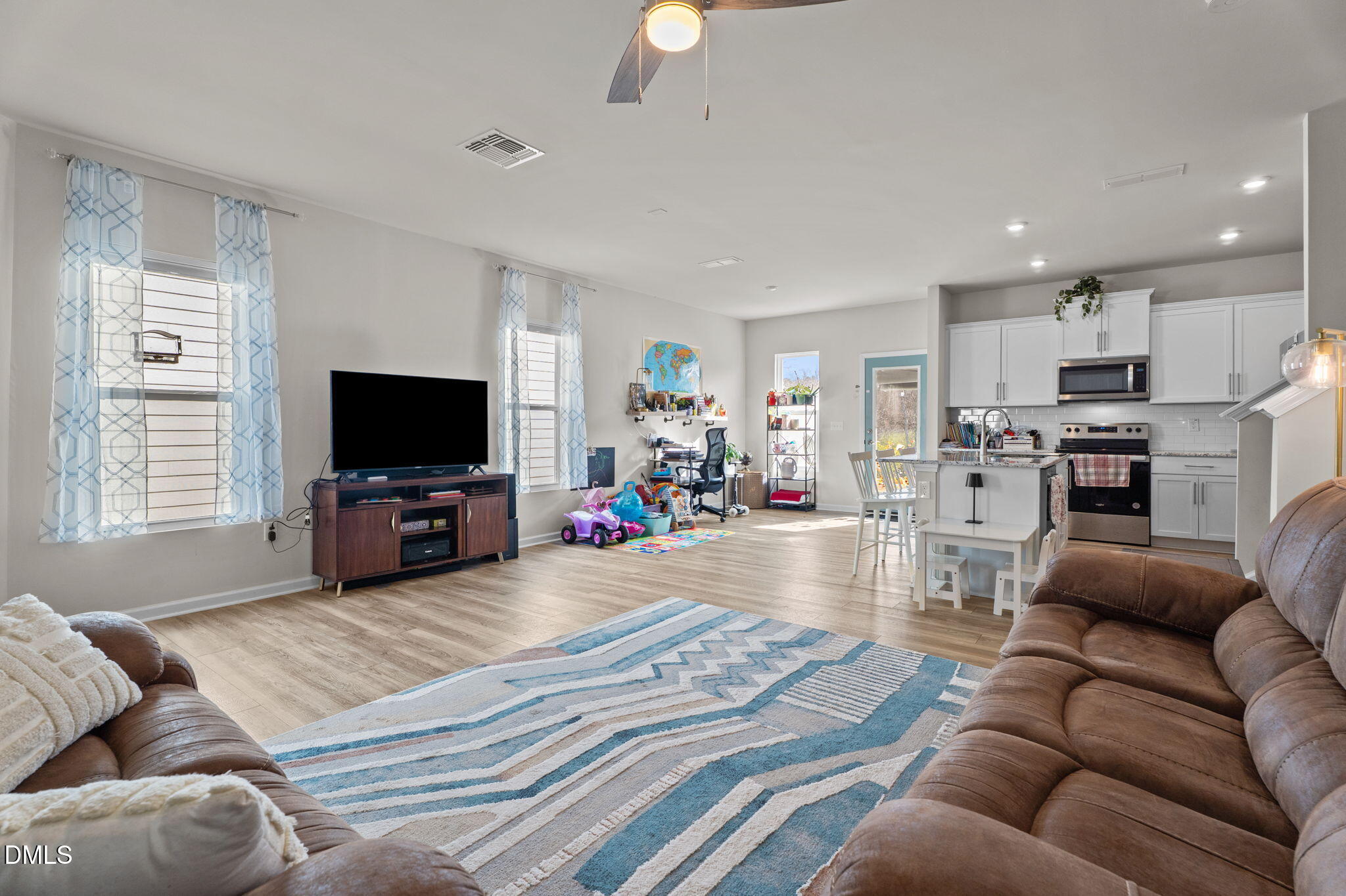 1572 Rhodes Pond Street Wendell, NC 27591 - Photo 12 of 42 a living room with furniture and a flat screen tv