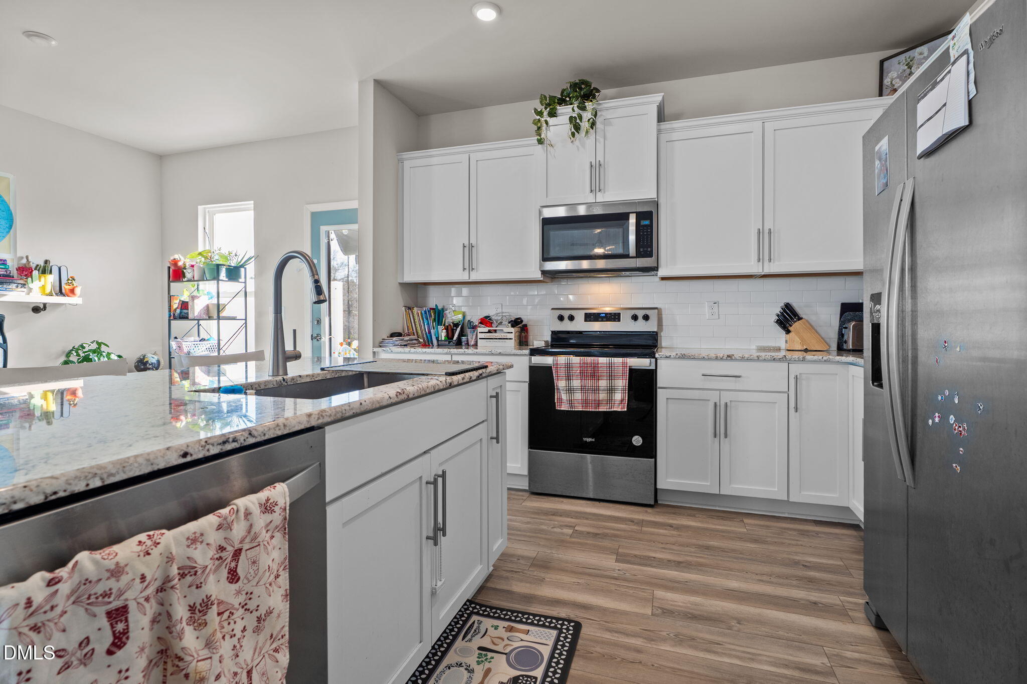 1572 Rhodes Pond Street Wendell, NC 27591 - Photo 16 of 42 a kitchen with stainless steel appliances granite countertop a sink stove and refrigerator