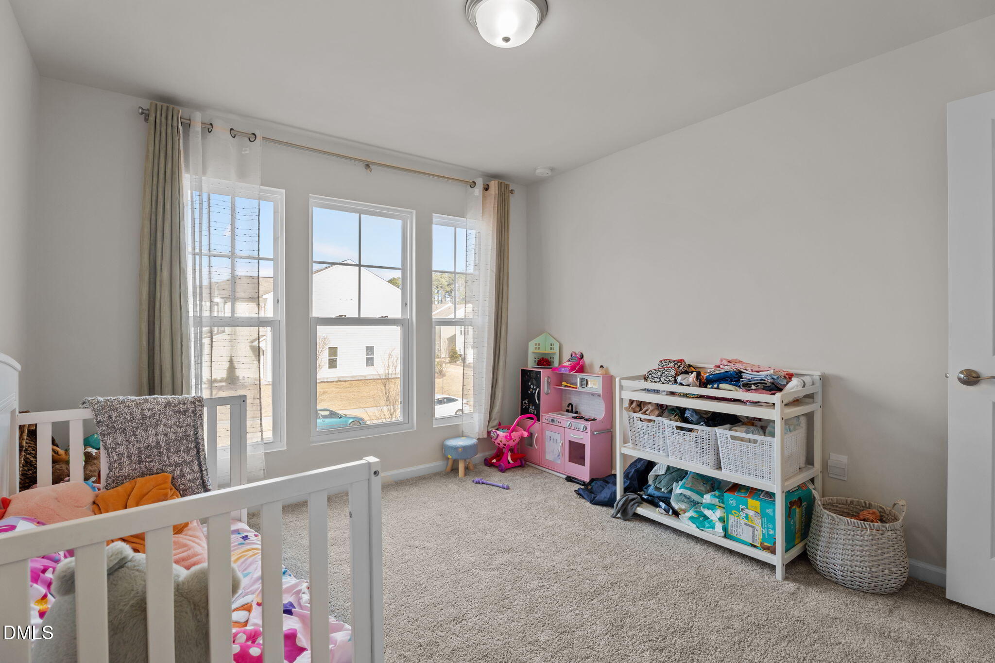 1572 Rhodes Pond Street Wendell, NC 27591 - Photo 32 of 42 a bedroom with furniture a baby crib and a wooden floor