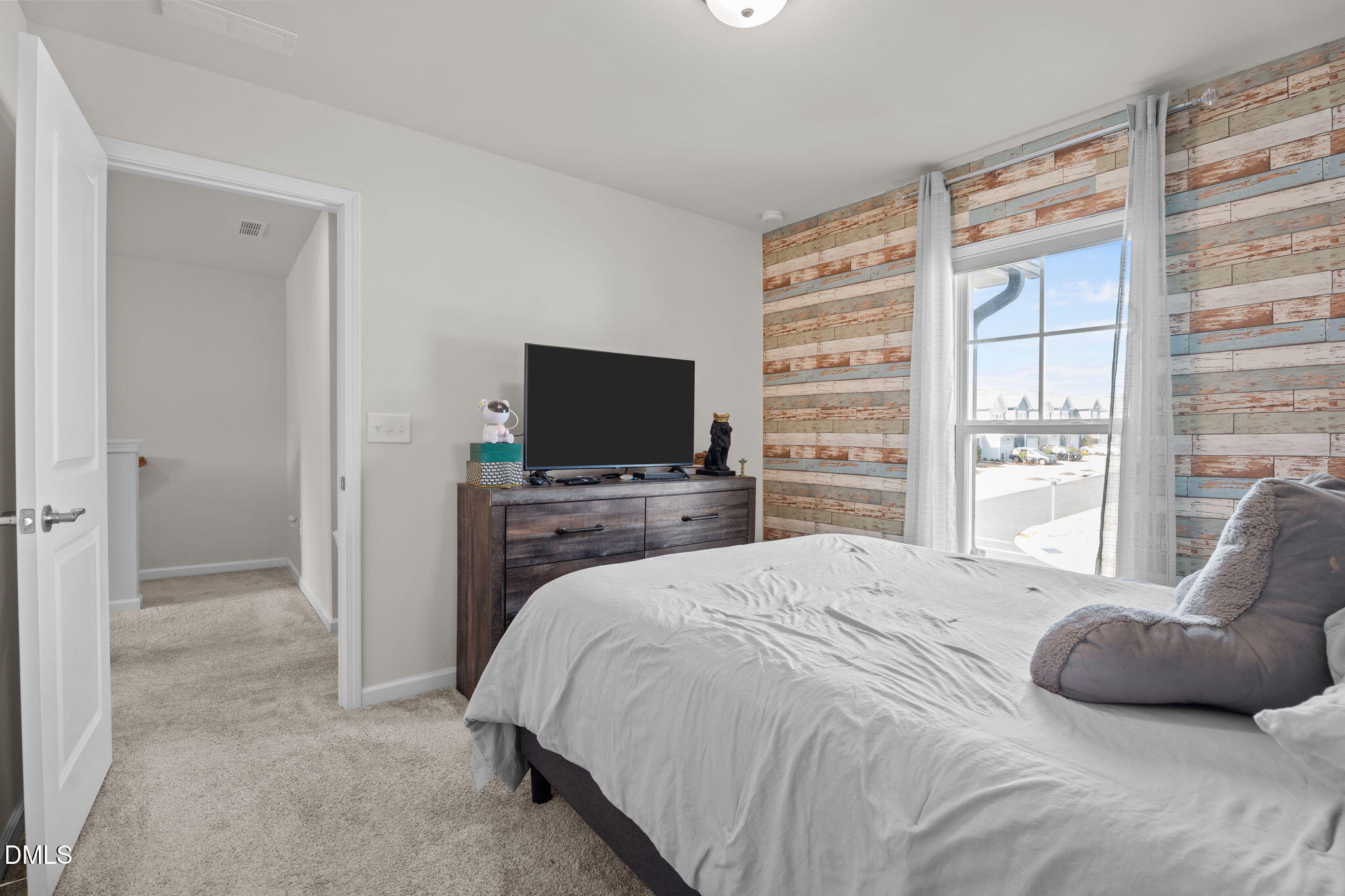 1572 Rhodes Pond Street Wendell, NC 27591 - Photo 35 of 42 a bedroom with a bed and a flat screen tv
